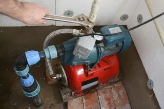Plumber working on well pump